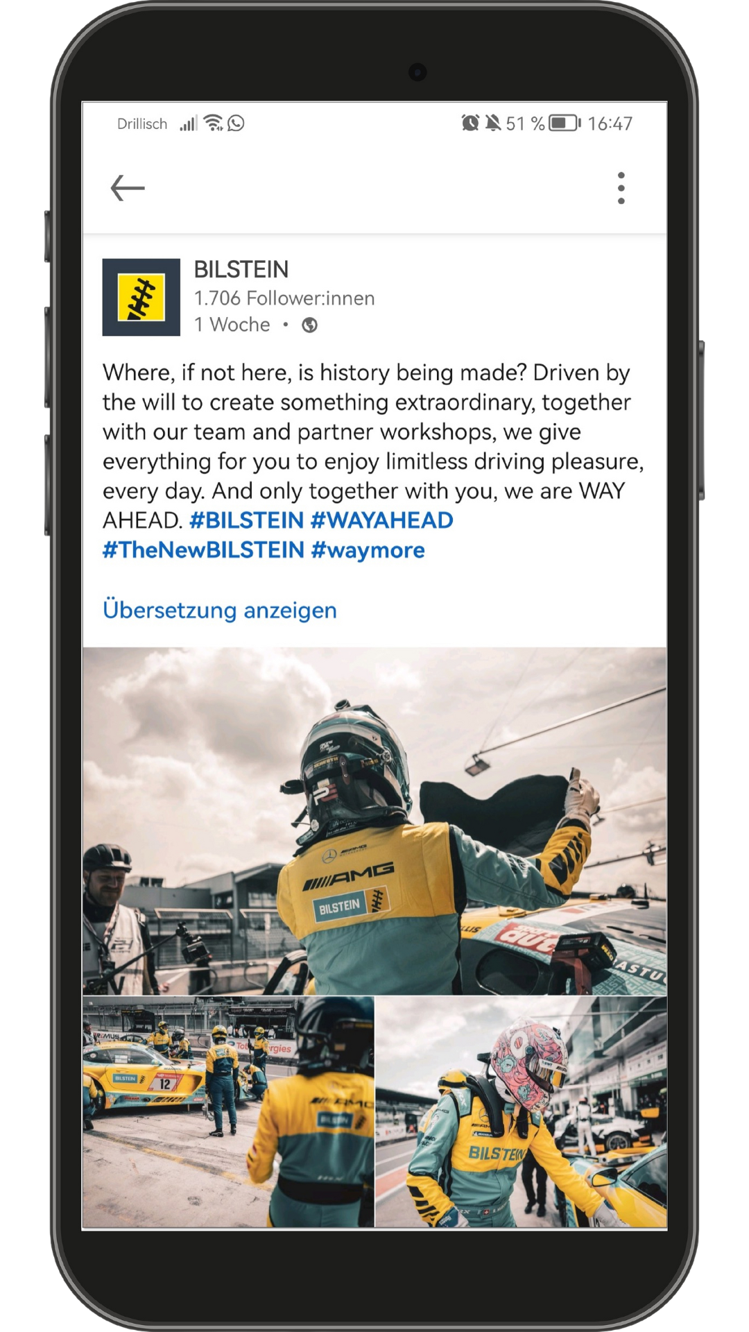 A smartphone screen displays a social media post by Bilstein, featuring a racing driver in yellow and turquoise gear celebrating on a racetrack. Several race cars and team members are visible in the background. The post highlights Bilstein’s commitment to driving pleasure and innovation.