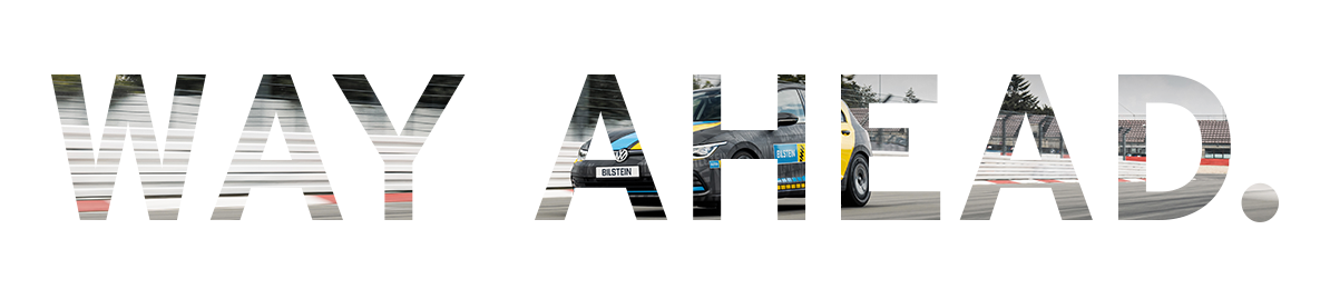 The phrase “WAY AHEAD.” is written in large, bold letters, with the image of a racing car on a track visible inside the text as a cut-out effect.